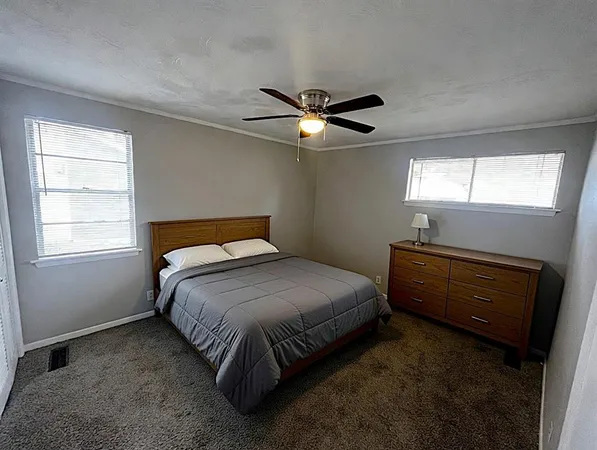 a bedroom with a bed and a chandelier
