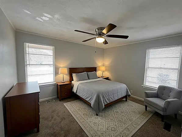a bedroom with a large bed and a window