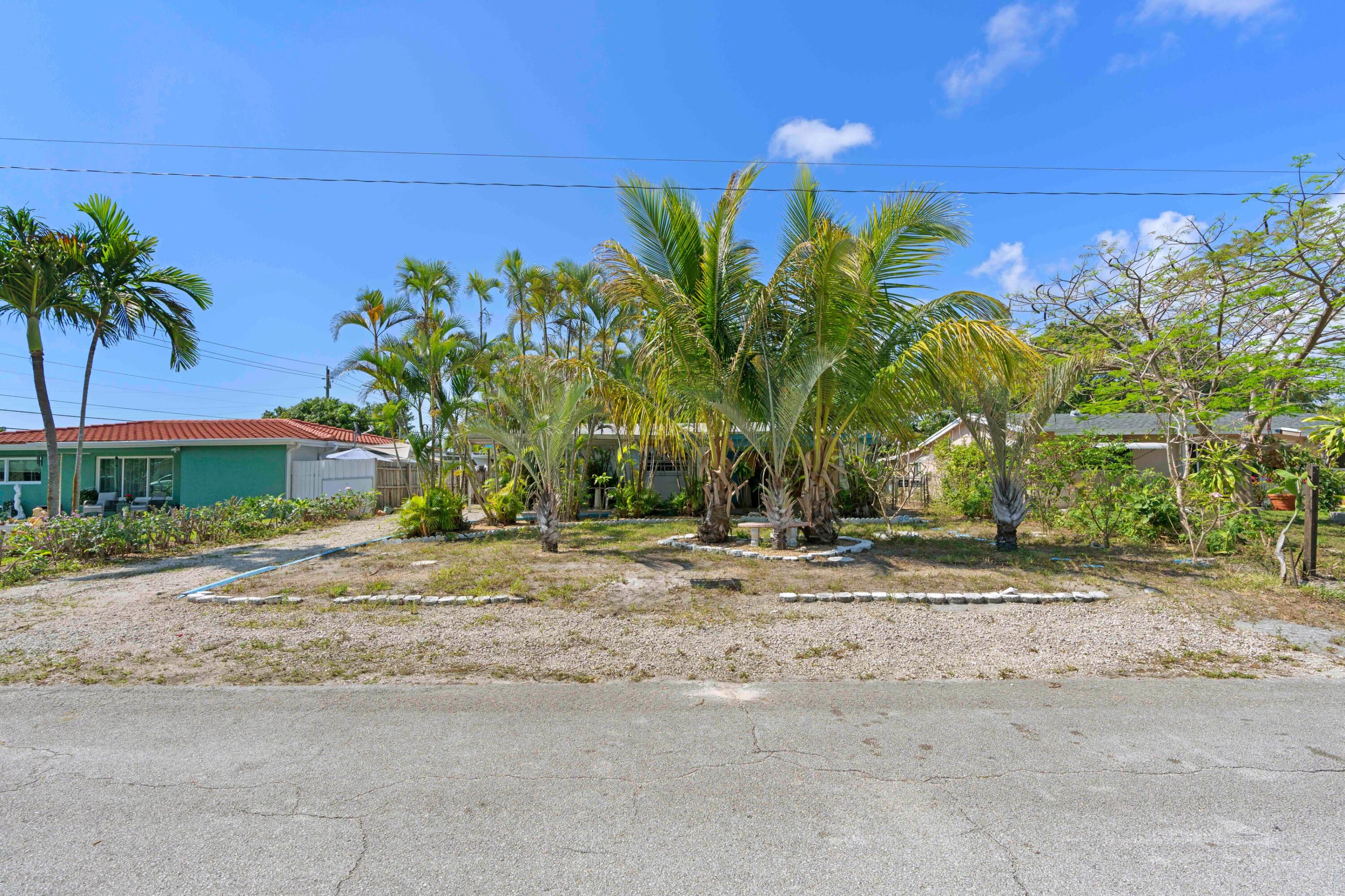310 Southwest 2nd Street Boca Raton, FL 33432 - Photo 2 of 17 a couple of palm trees in front of a house