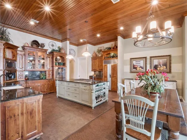 a large kitchen with a lot of cabinets and a wooden floor