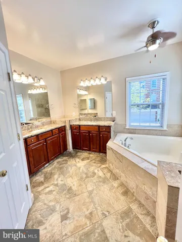 a large bathroom with a large tub and sink