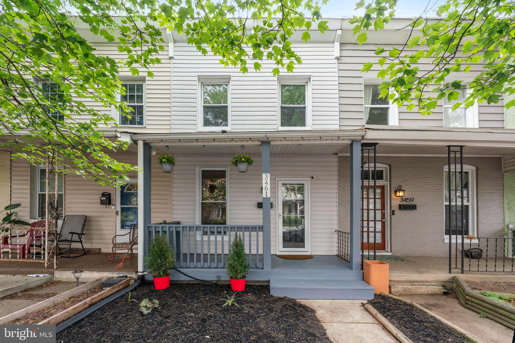 a view of a house with a small yard and potted plants
