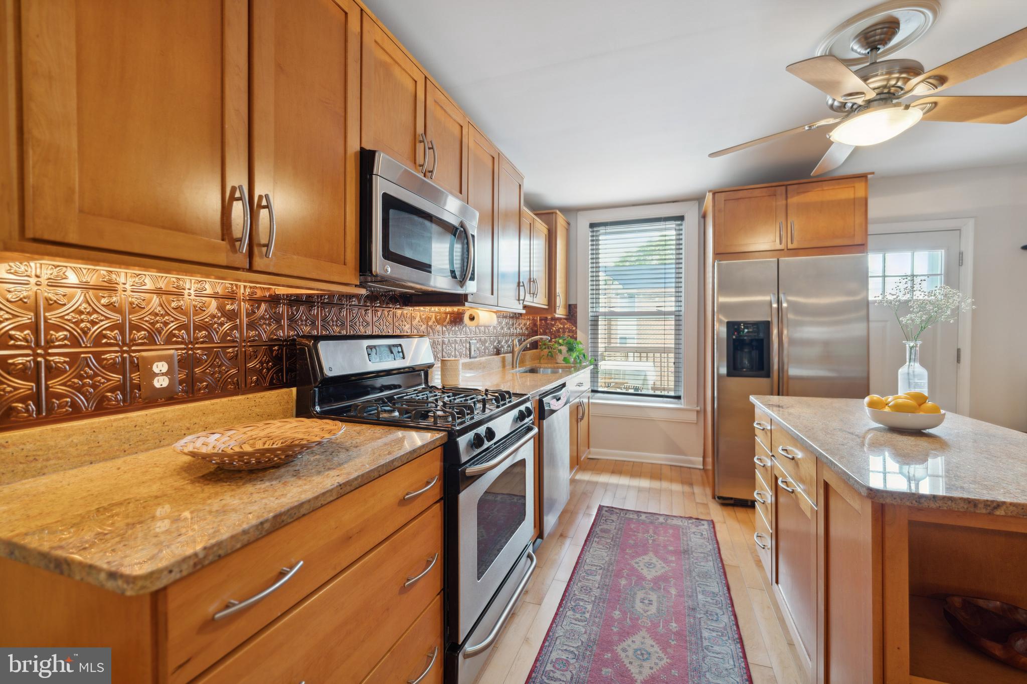 3461 Keswick Road Baltimore, MD 21211 - Photo 13 of 25 a kitchen with granite countertop a stove and a sink