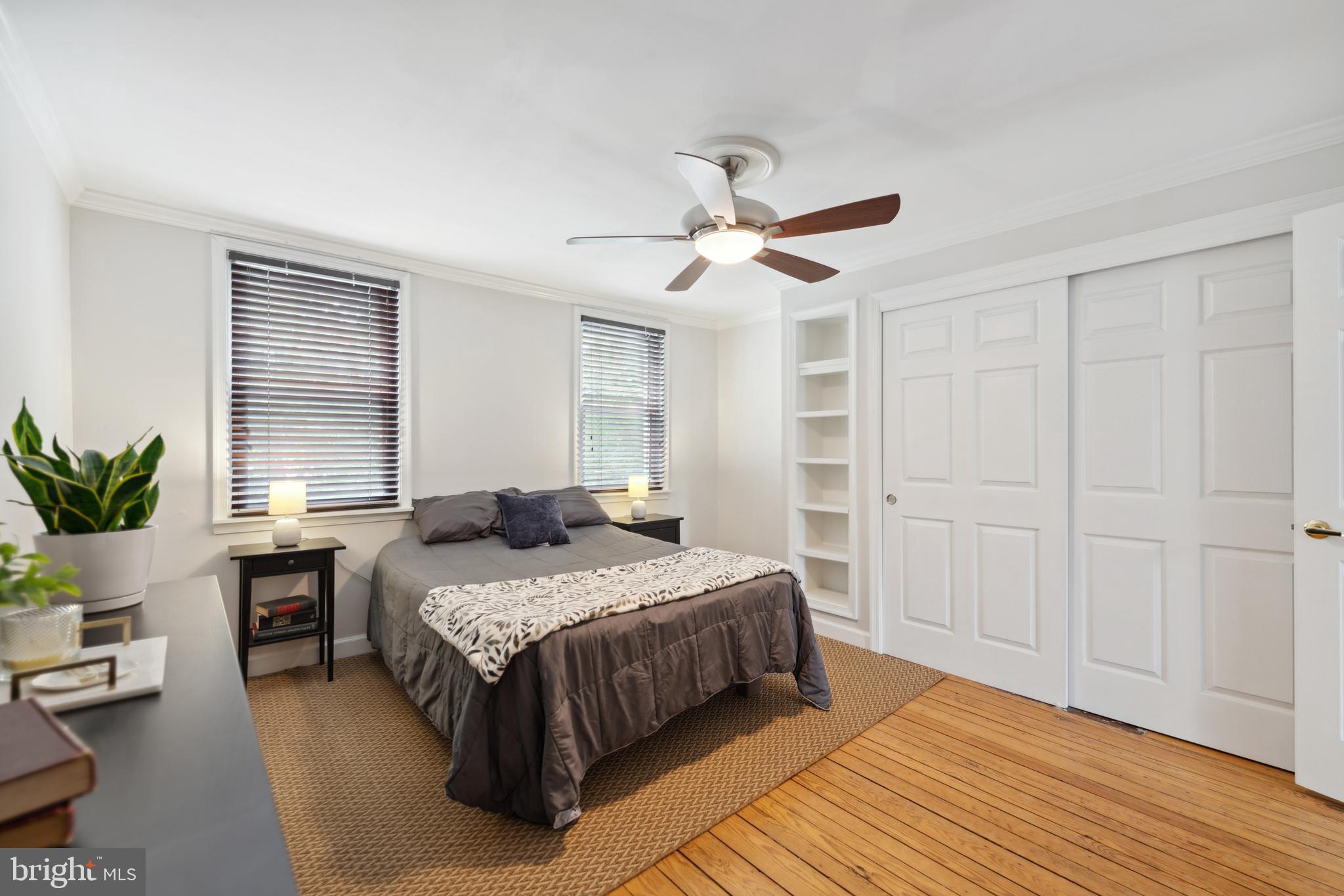 3461 Keswick Road Baltimore, MD 21211 - Photo 19 of 25 a bedroom with a large bed and a chandelier