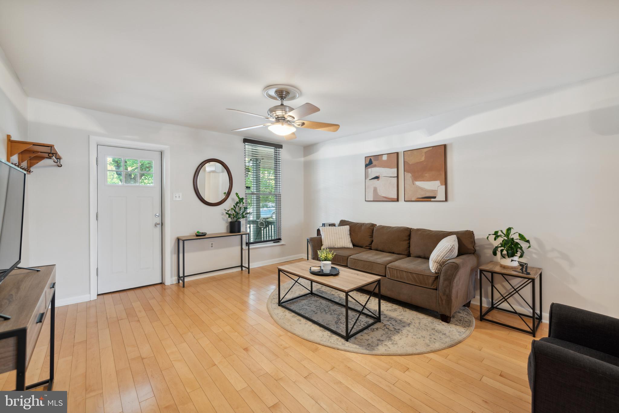 3461 Keswick Road Baltimore, MD 21211 - Photo 3 of 25 a living room with furniture a clock and a window