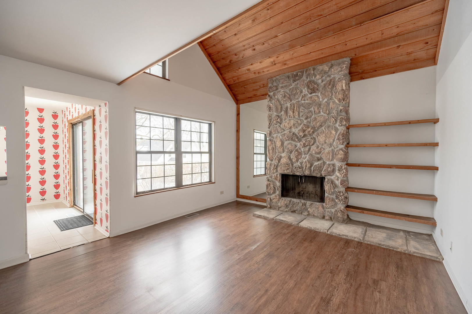 586 Dunham Road Gurnee, IL 60031 - Photo 3 of 13 a view of empty room with fireplace and wooden floor