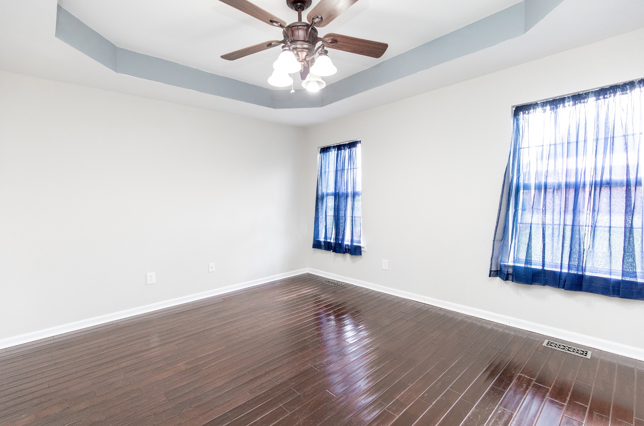 443 Clearview Road Cottontown, TN 37048 - Photo 7 of 21 an empty room with wooden floor fan and windows