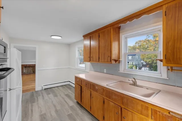 a kitchen with a sink and wooden cabinets