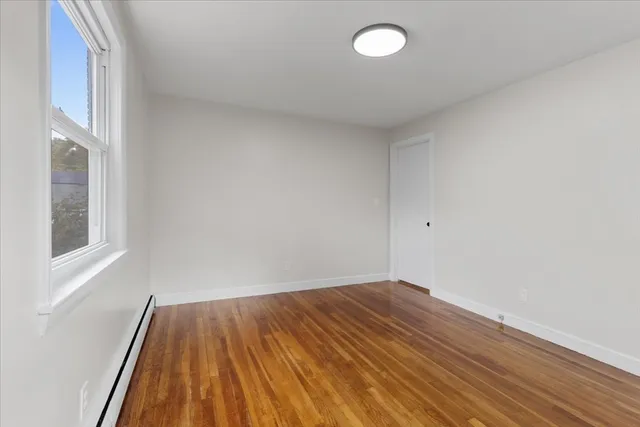 a view of room with wooden floor and fan