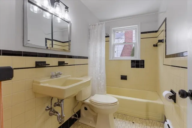 a bathroom with a sink mirror toilet and bathtub
