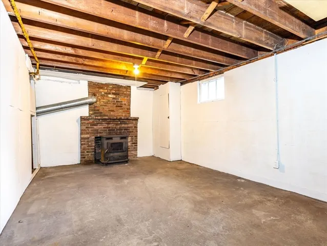 a view of empty room with a fireplace