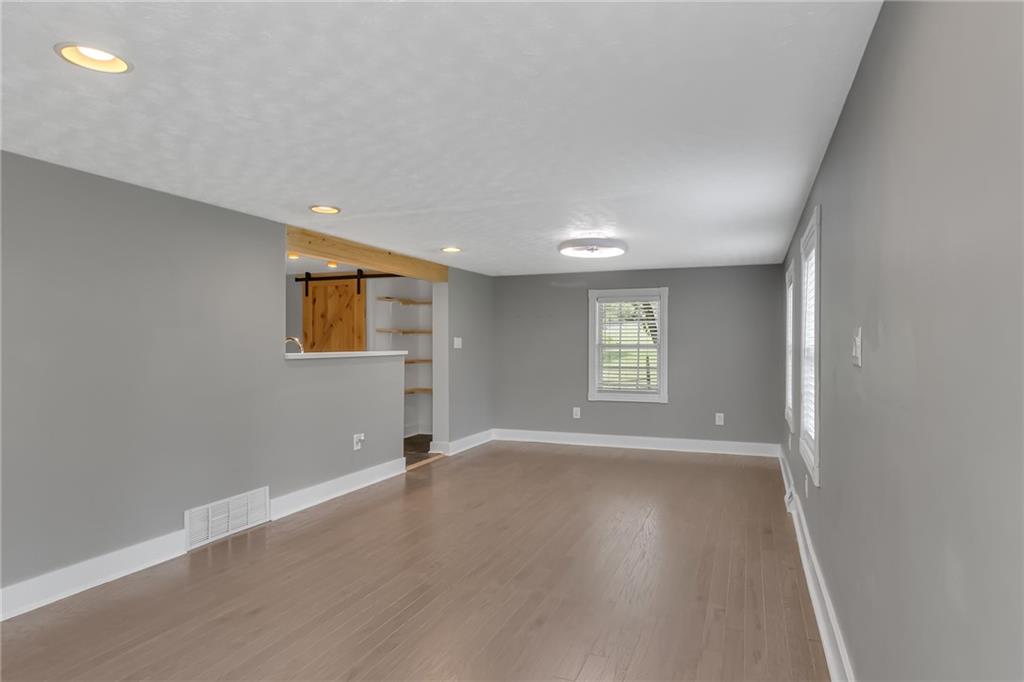 143 Inman Drive New Brighton, PA 15066 - Photo 10 of 29 an empty room with wooden floor and windows