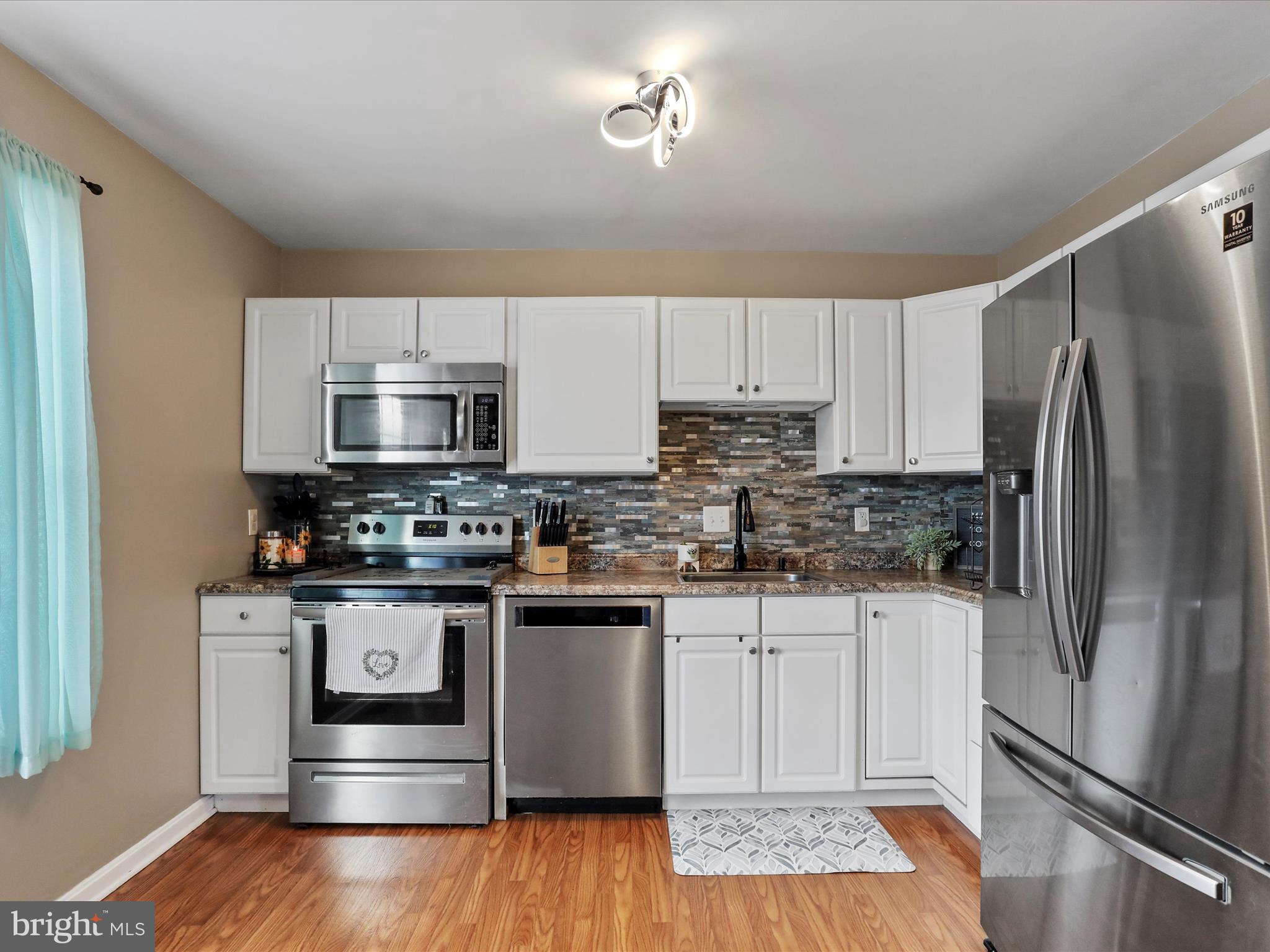 15 Snail Kite Road Martinsburg, WV 25405 - Photo 11 of 37 a kitchen with stainless steel appliances granite countertop a refrigerator a stove top oven a sink and dishwasher