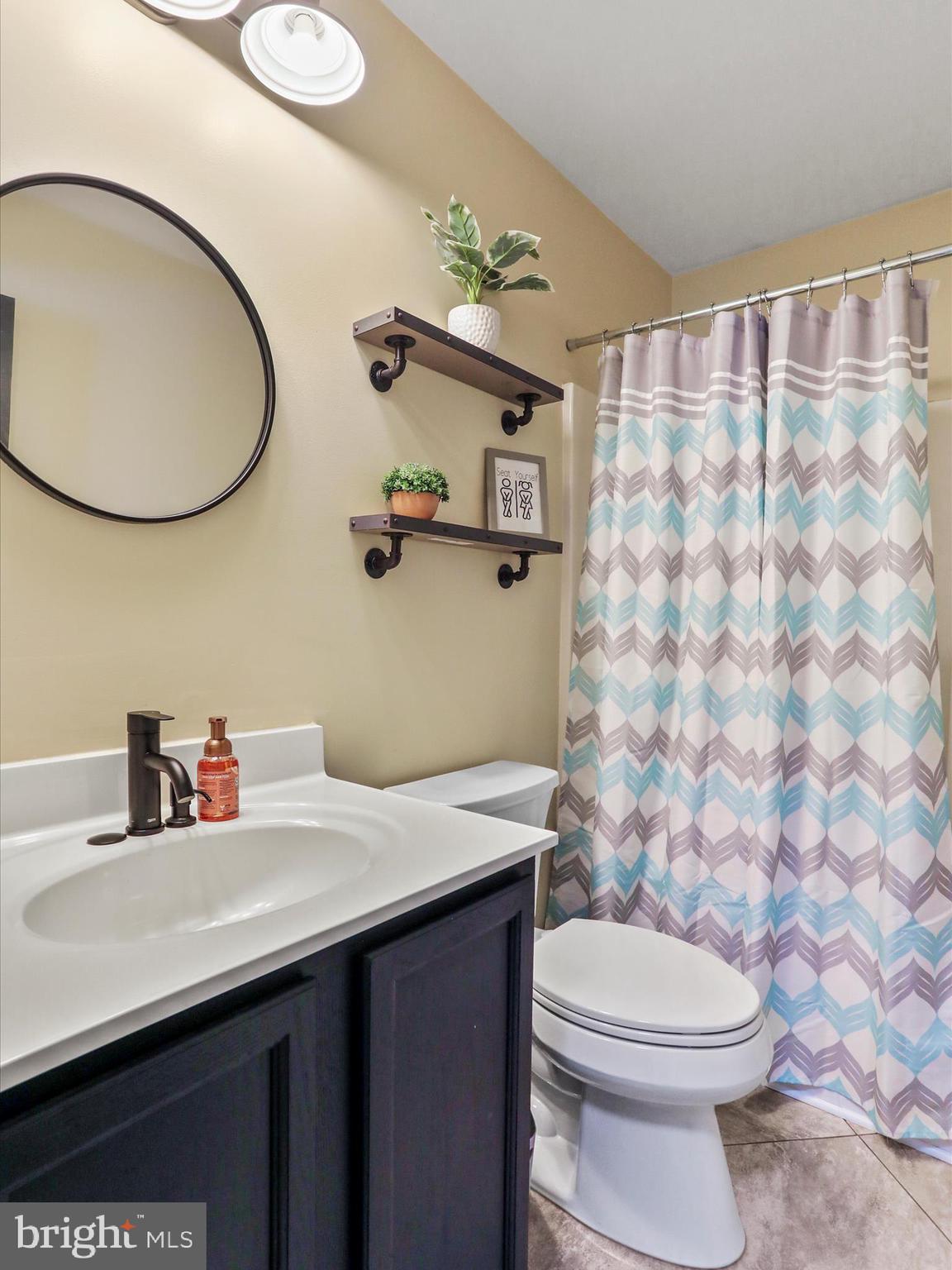 15 Snail Kite Road Martinsburg, WV 25405 - Photo 26 of 37 a bathroom with a sink vanity mirror and toilet
