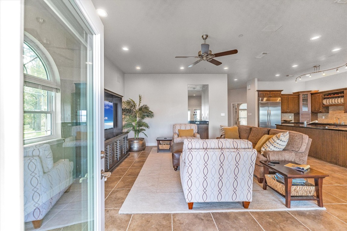 191 Beth Circle Huntsville, TX 77320 - Photo 15 of 50 With French doors framing lake views and easy access to the covered patio, this open family room combines relaxation and entertaining with ease. A convenient wet bar adds the perfect touch for hosting gatherings or enjoying quiet evenings by the water.