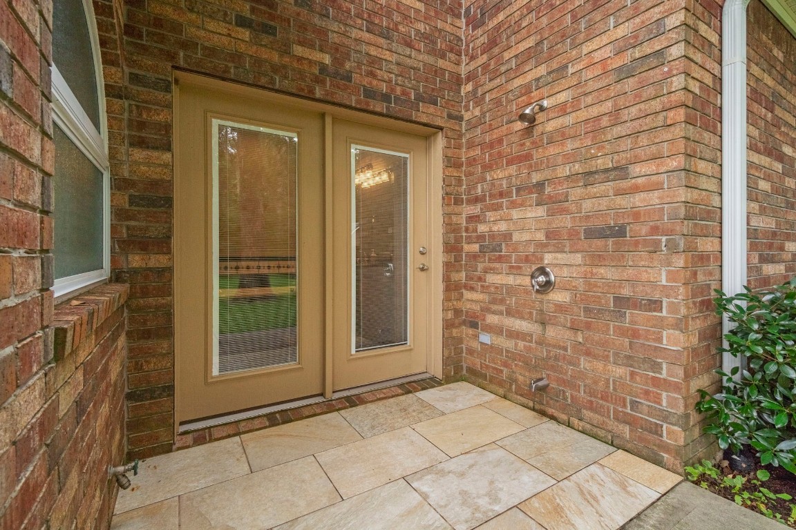 191 Beth Circle Huntsville, TX 77320 - Photo 24 of 50 This private patio is off of the owner's ensuite and offers an outdoor shower to clean up after long day playing on the water.