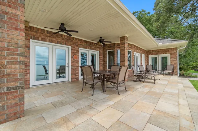 a view of a patio with table and chairs and potted plants