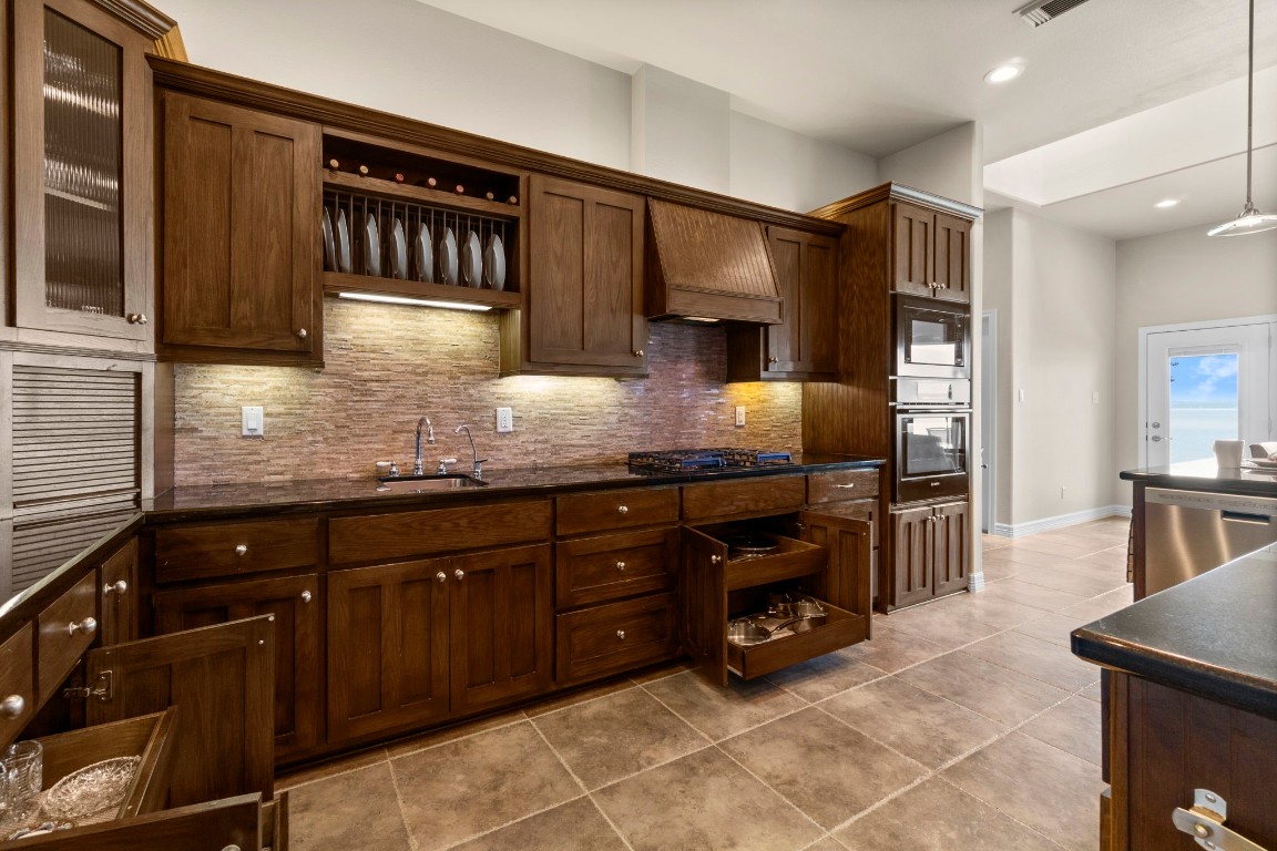 191 Beth Circle Huntsville, TX 77320 - Photo 7 of 50 a kitchen with granite countertop a sink and cabinets