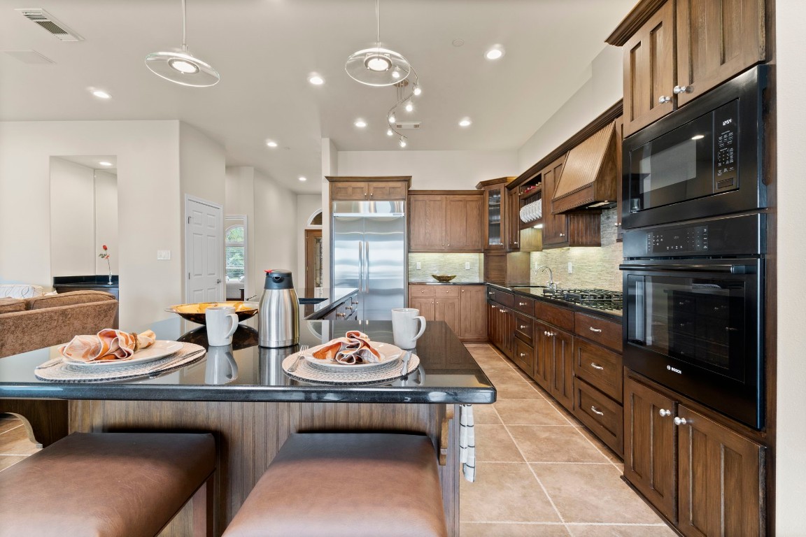 191 Beth Circle Huntsville, TX 77320 - Photo 9 of 50 You’ll enjoy morning coffee, late night snacks, and everything in between in this stunning island kitchen with a welcoming vibe and effortless flow. With bar seating, rich cabinetry, and a spacious open layout, it’s the perfect spot to gather, cook, and make memories together.