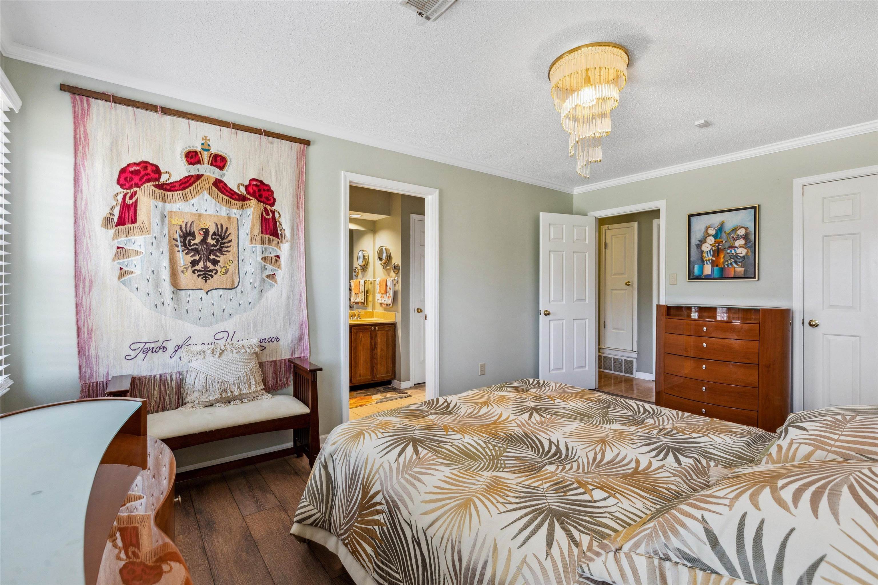6972 Crestridge Road Memphis, TN 38119 - Photo 16 of 26 Bedroom with wood-type flooring, ornamental molding, connected bathroom, and visible vents