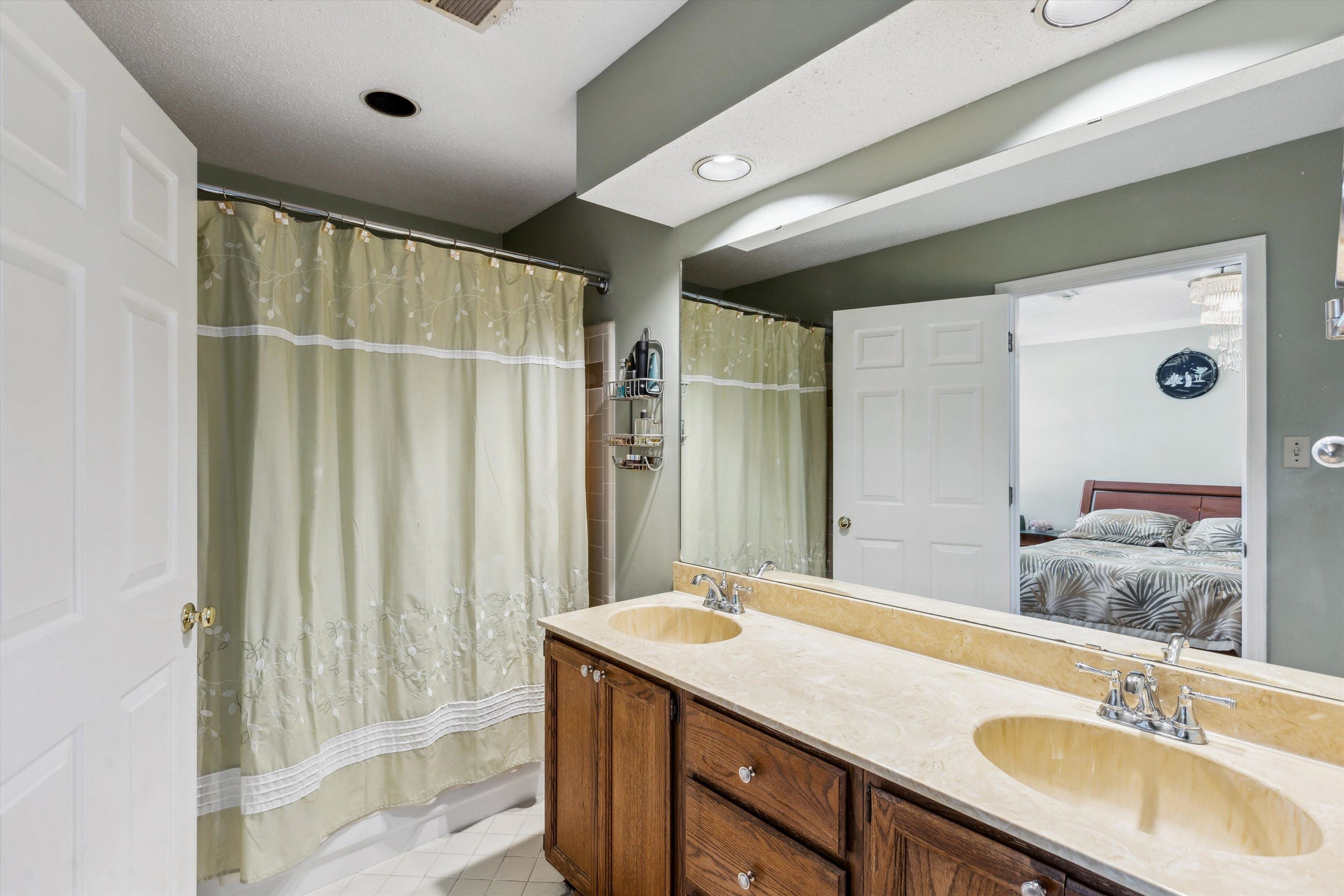 6972 Crestridge Road Memphis, TN 38119 - Photo 17 of 26 Bathroom with connected bathroom, double vanity, a shower with shower curtain, and a sink