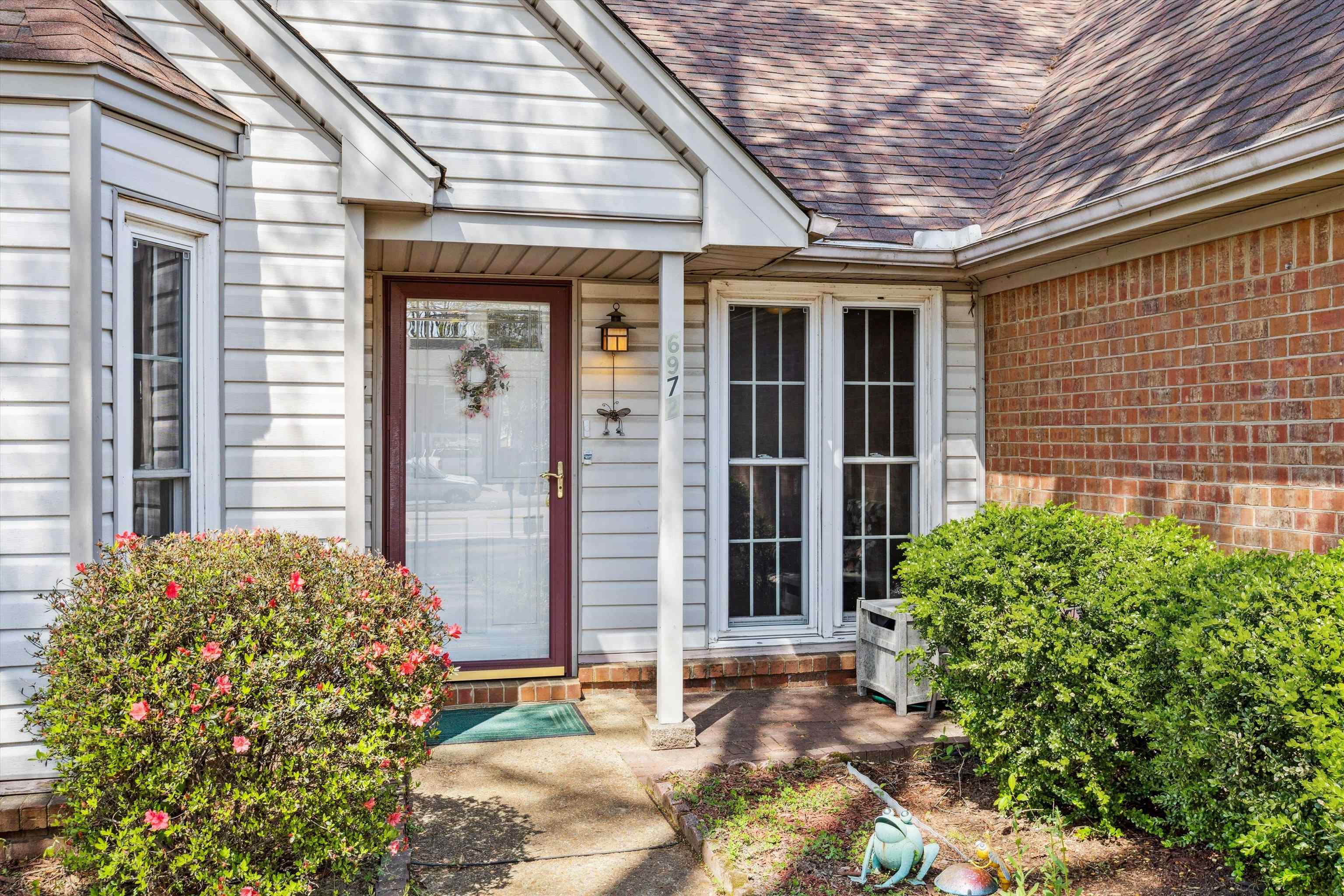 6972 Crestridge Road Memphis, TN 38119 - Photo 3 of 26 View of exterior entry featuring roof with shingles