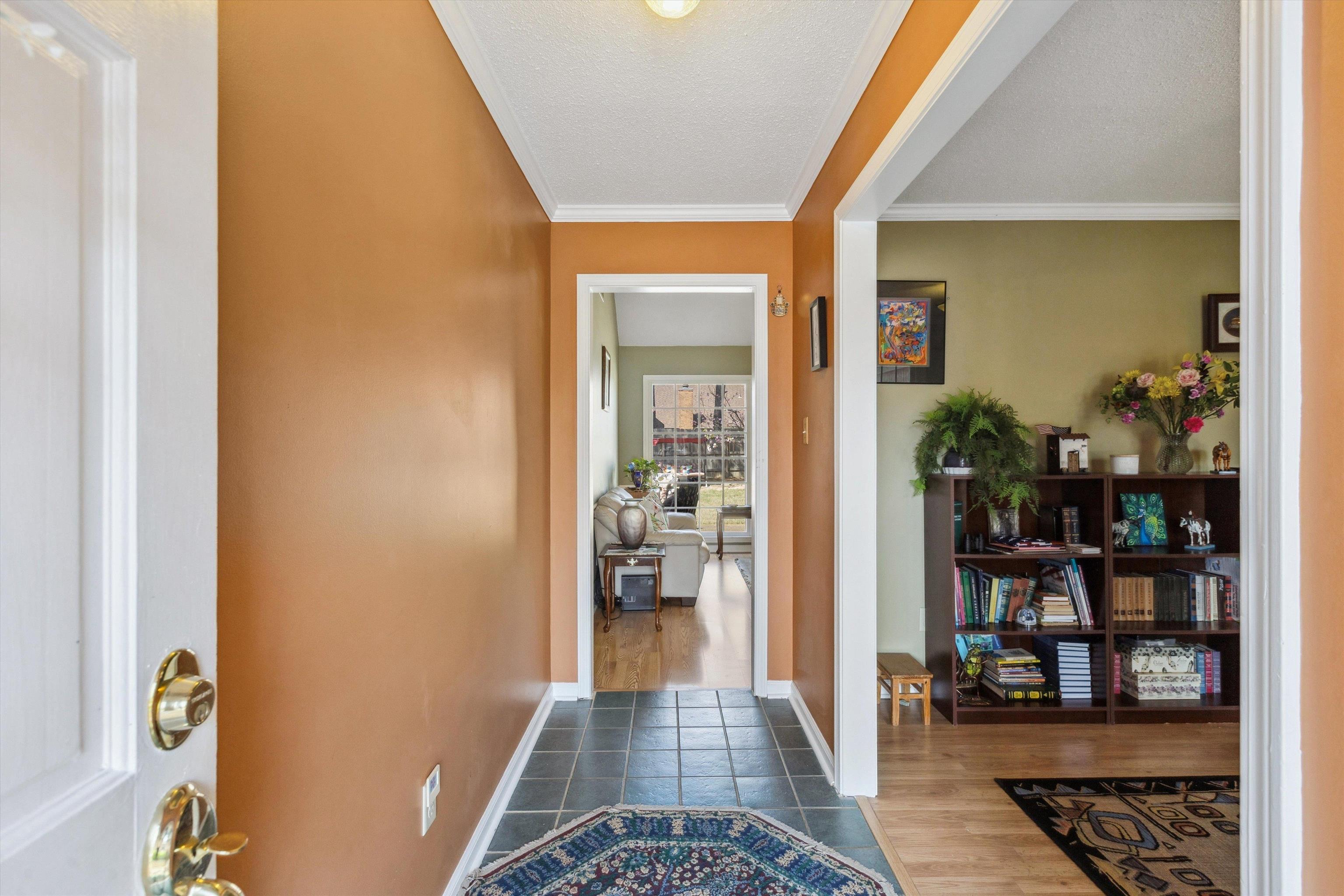 6972 Crestridge Road Memphis, TN 38119 - Photo 4 of 26 Entryway with crown molding, baseboards, and dark wood finished floors