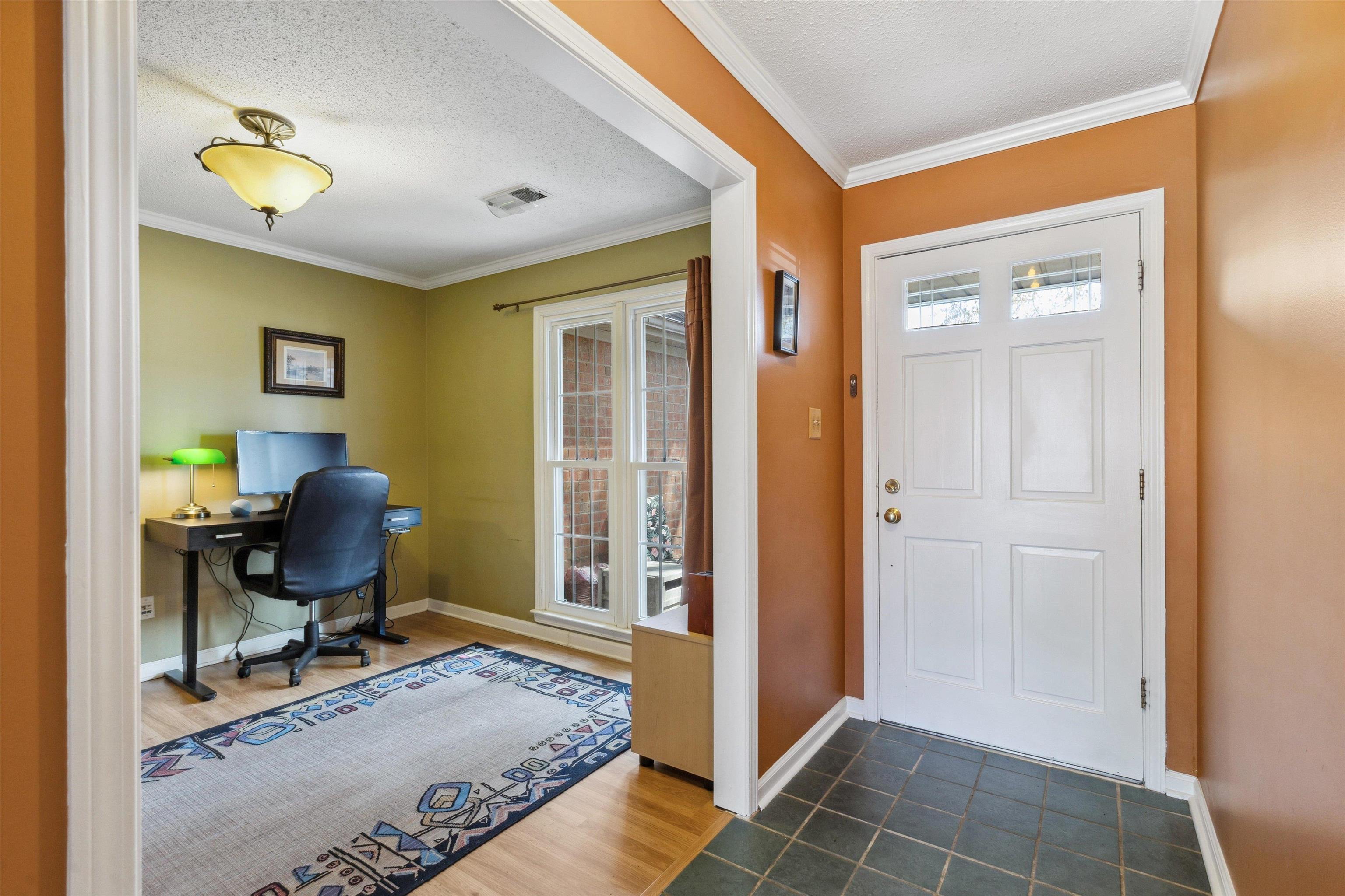 6972 Crestridge Road Memphis, TN 38119 - Photo 5 of 26 Foyer featuring baseboards, a textured ceiling, visible vents, and crown molding