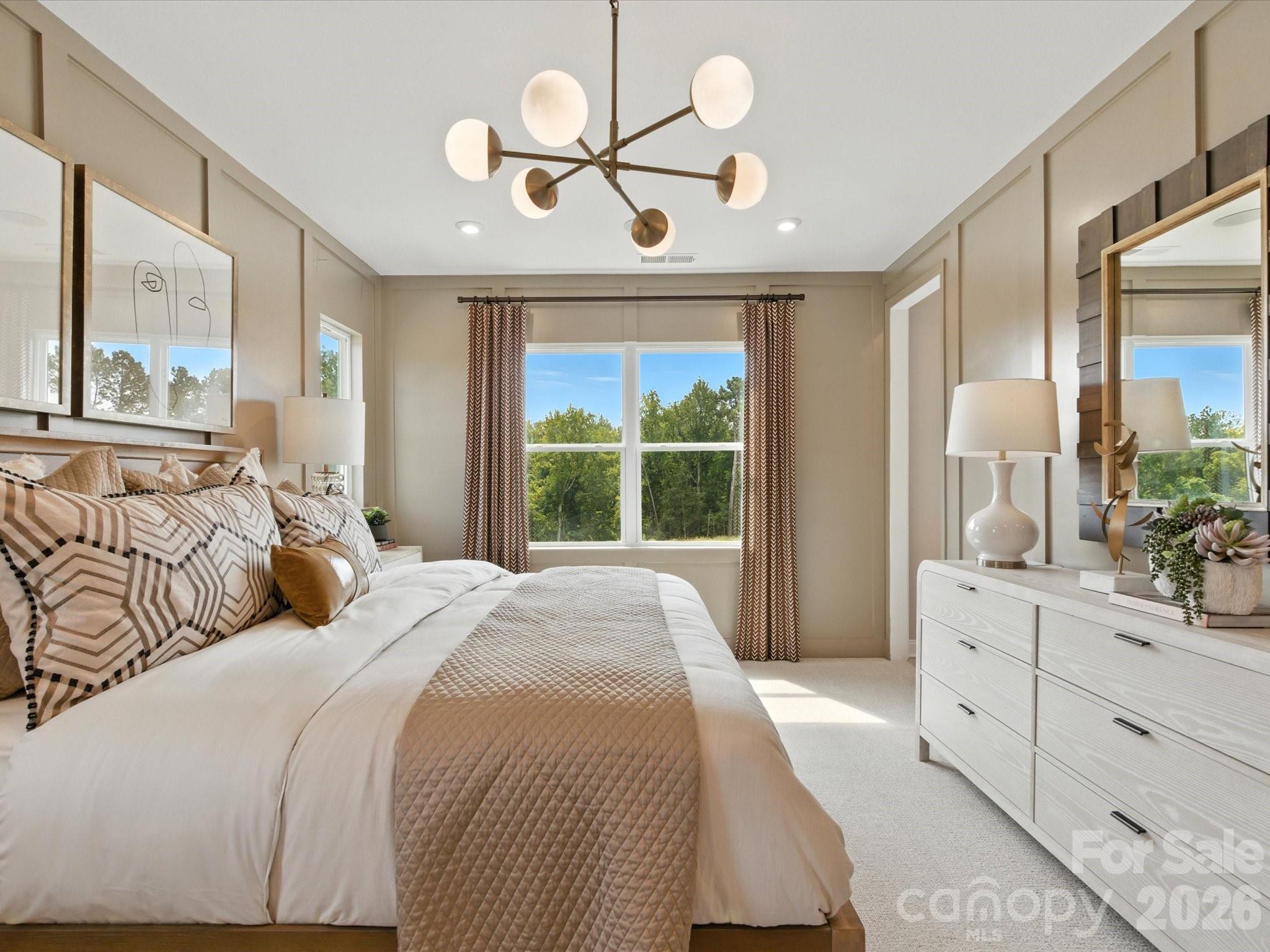 412 Nash Street Fort Mill, SC 29715 - Photo 16 of 21 a bedroom with a large bed and a chandelier