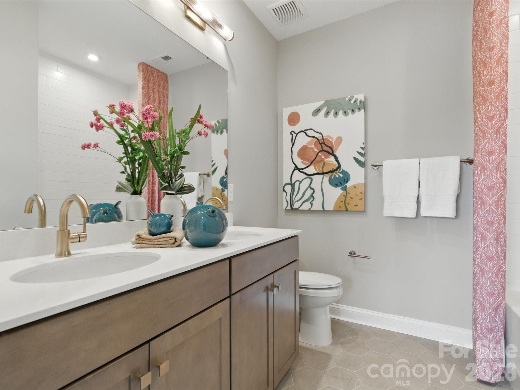 412 Nash Street Fort Mill, SC 29715 - Photo 21 of 21 a bathroom with a sink a large mirror and a toilet