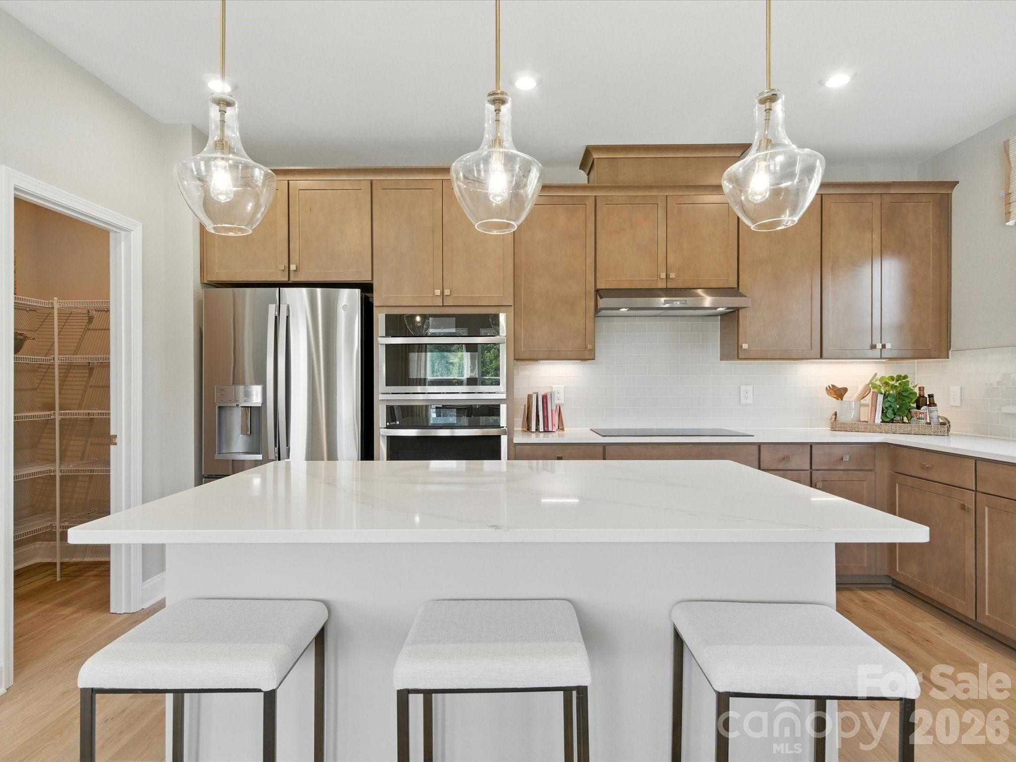 412 Nash Street Fort Mill, SC 29715 - Photo 5 of 21 a kitchen with cabinets a center island and stainless steel appliances