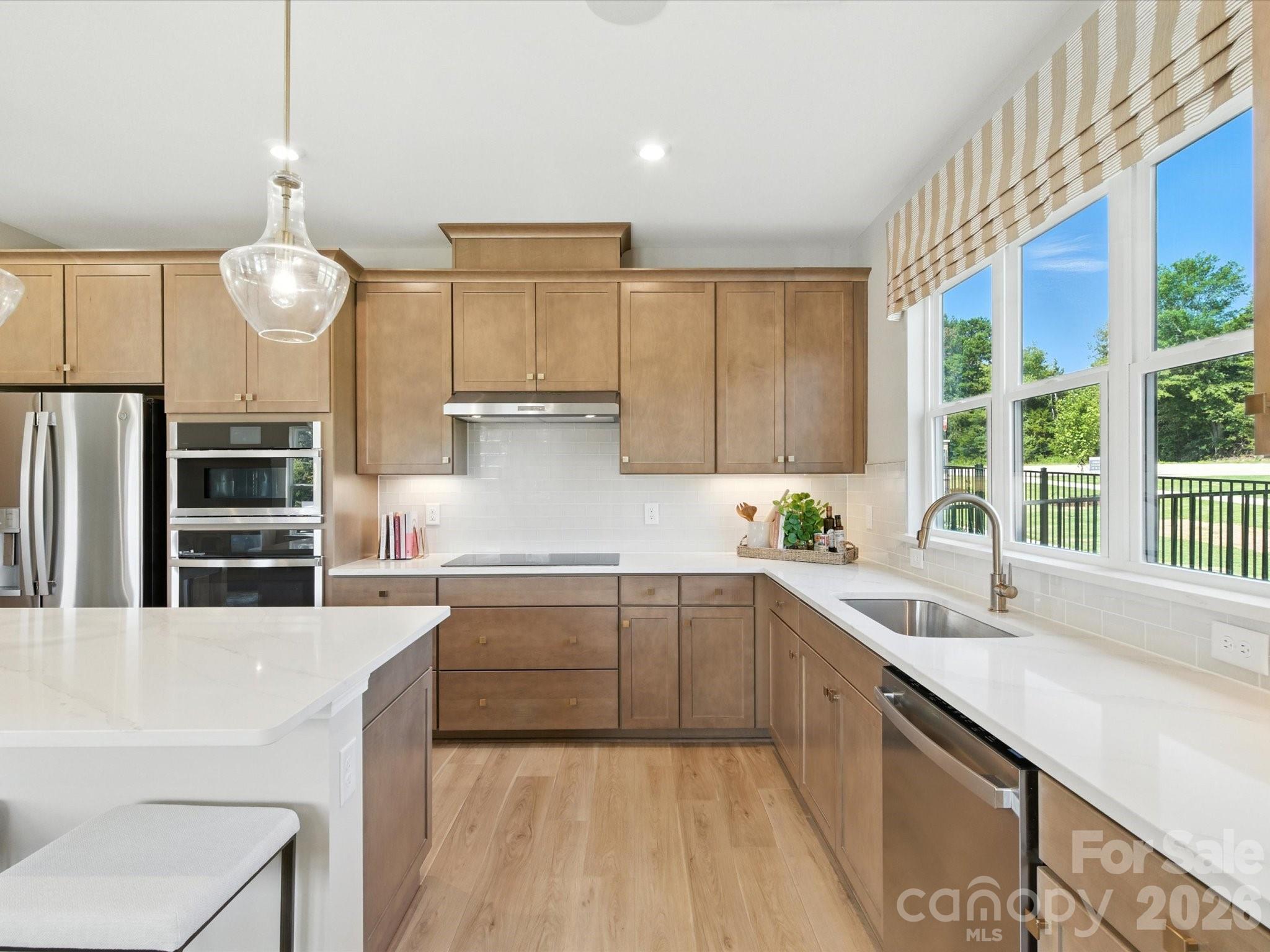 412 Nash Street Fort Mill, SC 29715 - Photo 6 of 21 a kitchen with stainless steel appliances a sink stove and cabinets