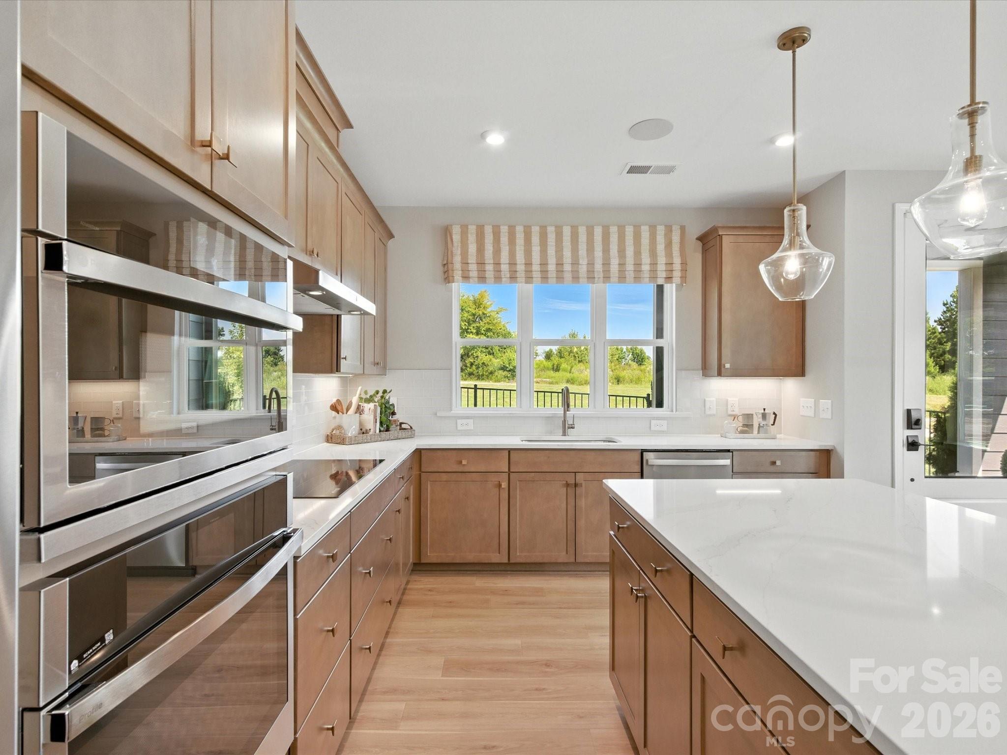 412 Nash Street Fort Mill, SC 29715 - Photo 8 of 21 a large kitchen with stainless steel appliances lots of counter space and a sink