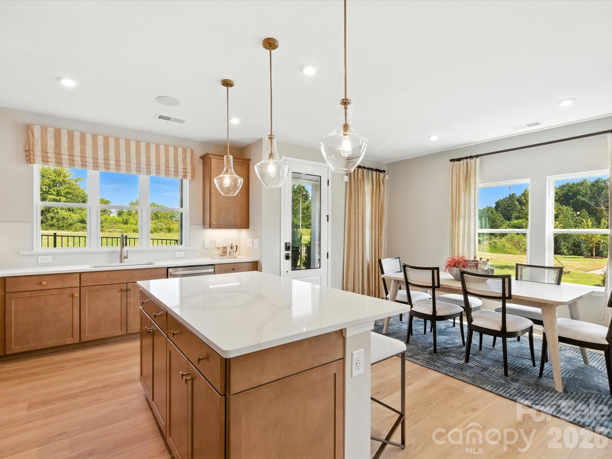 412 Nash Street Fort Mill, SC 29715 - Photo 9 of 21 an open kitchen with a table and chairs in it