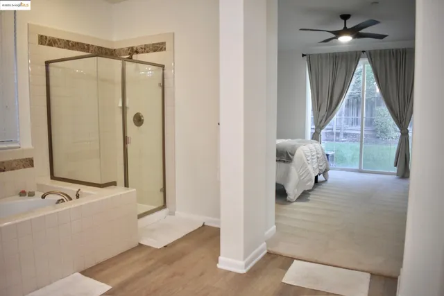 a bathroom with a tub and a shower