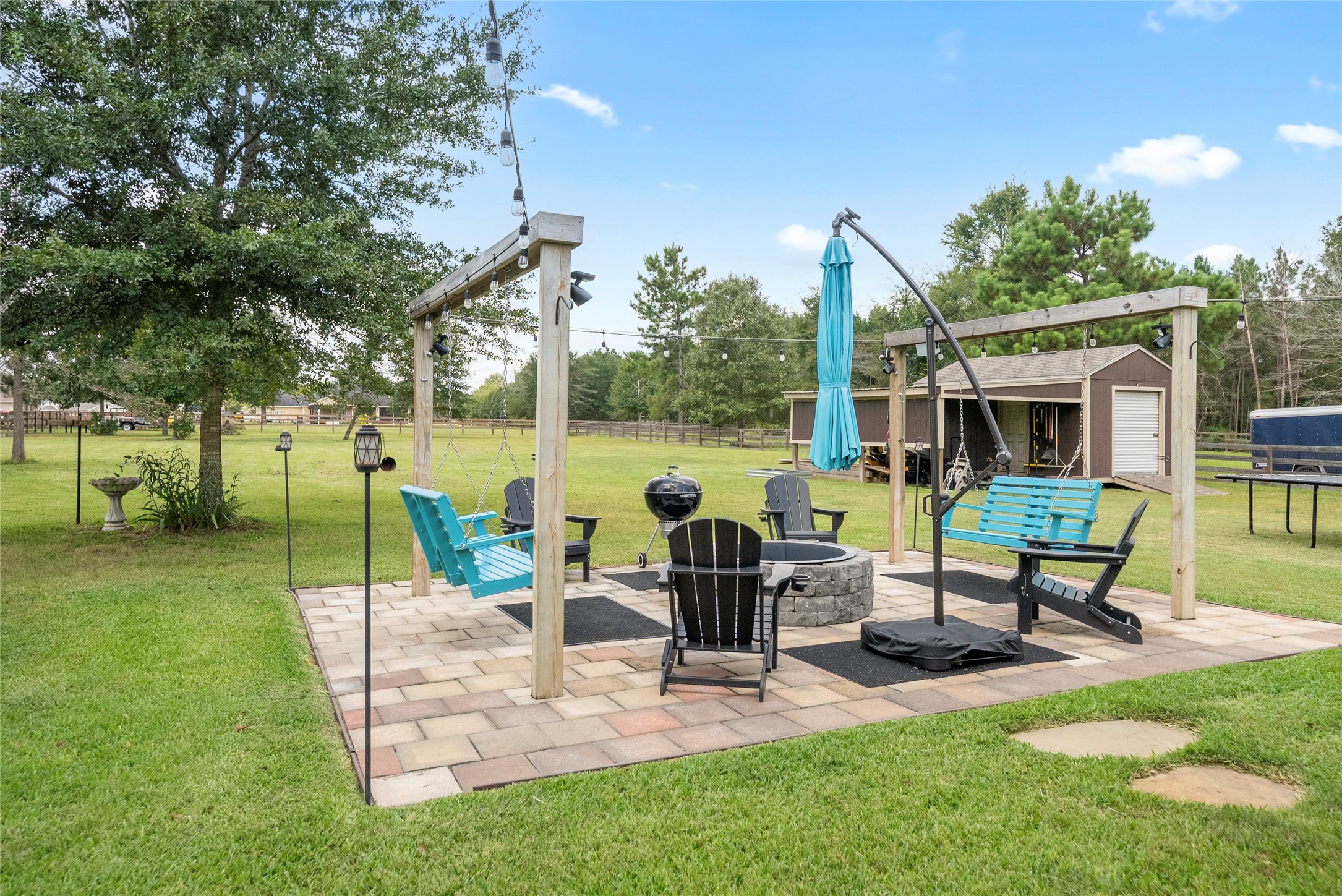 9160 Wapiti Trail Conroe, TX 77303 - Photo 27 of 48 This cozy firepit are includes swings and and cozy lighting.