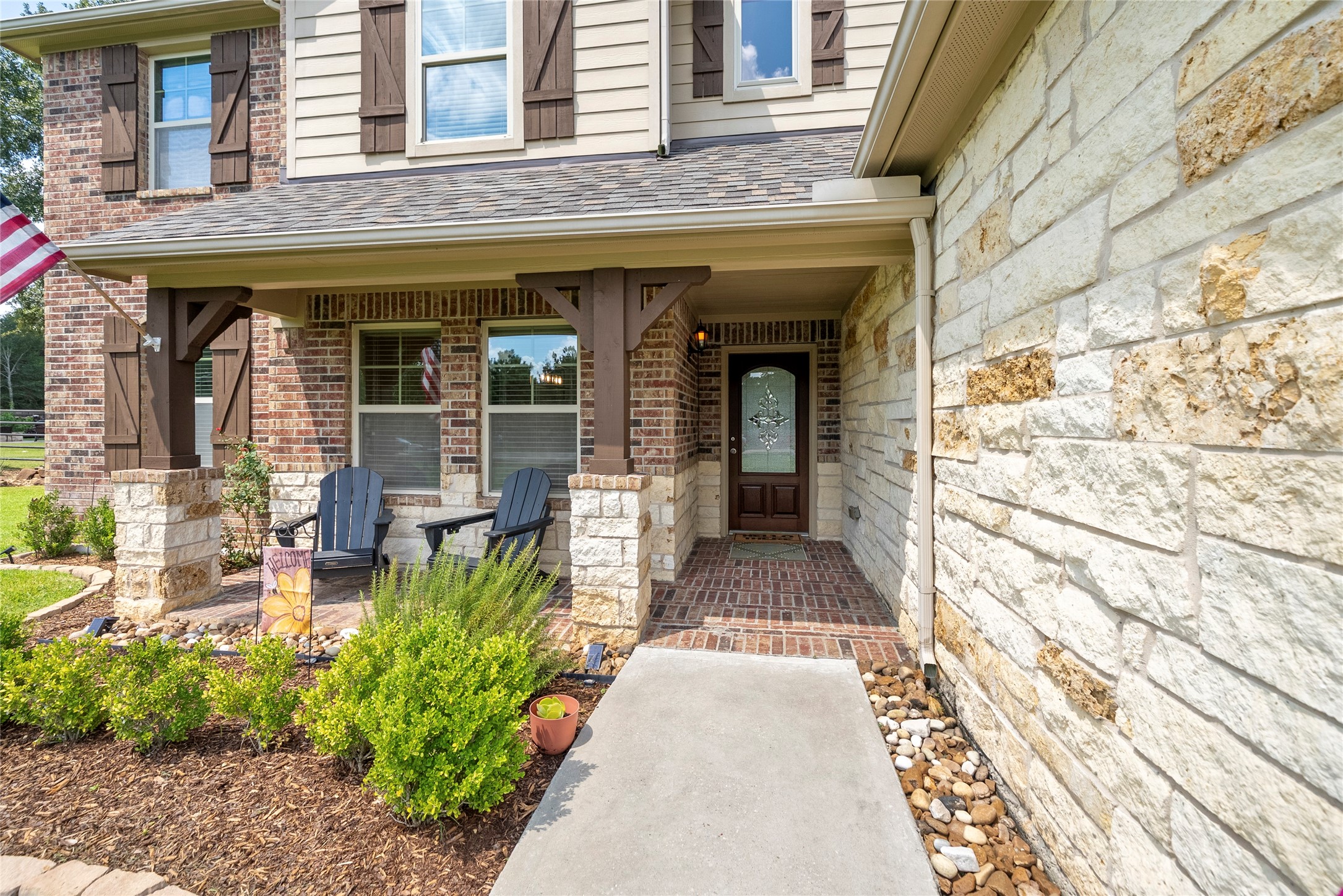 9160 Wapiti Trail Conroe, TX 77303 - Photo 3 of 48 Inviting front porch with sitting area and beautifully landscaped area.