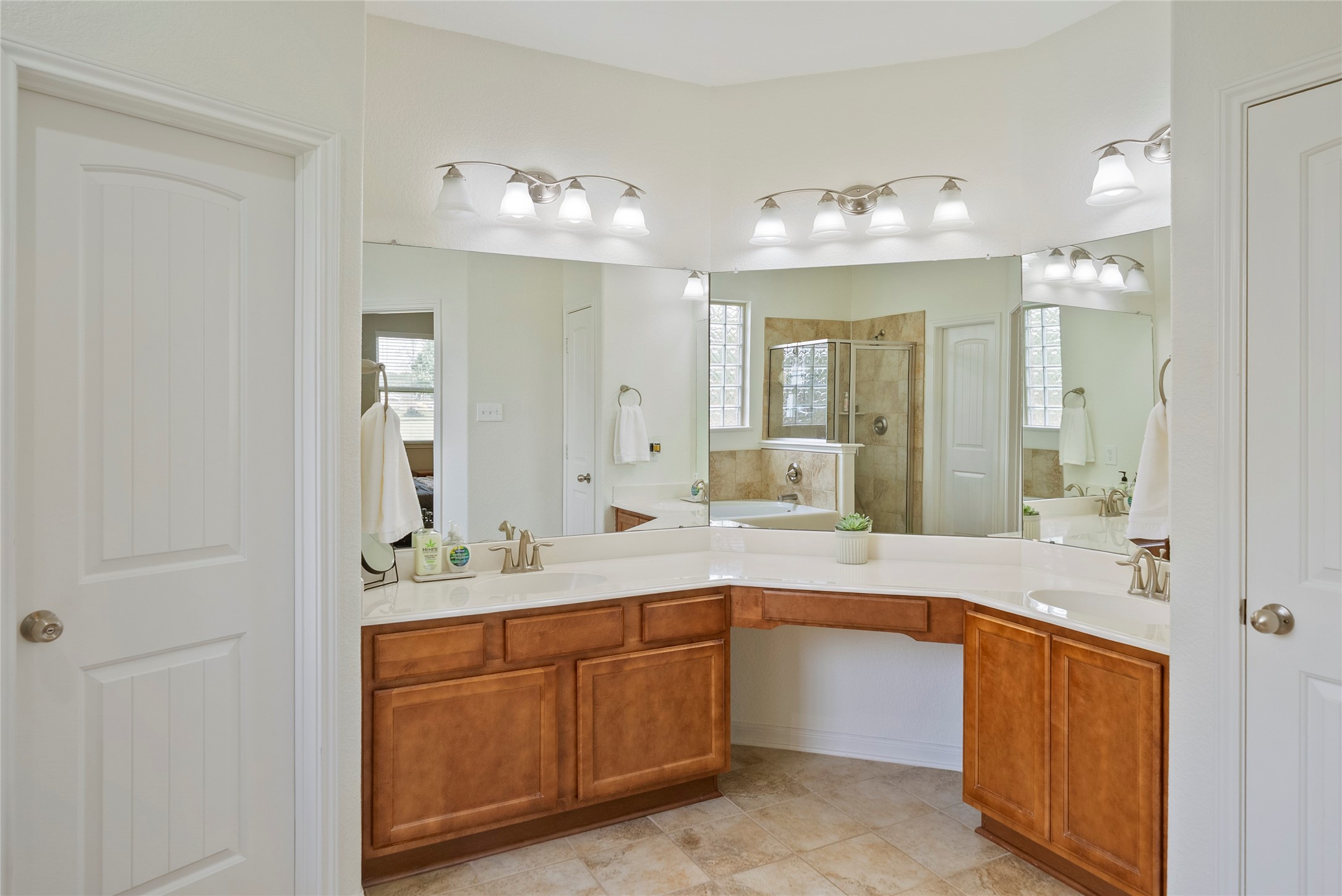 9160 Wapiti Trail Conroe, TX 77303 - Photo 9 of 48 Spacious primary bathroom with double sinks and dedicated sitting area.
