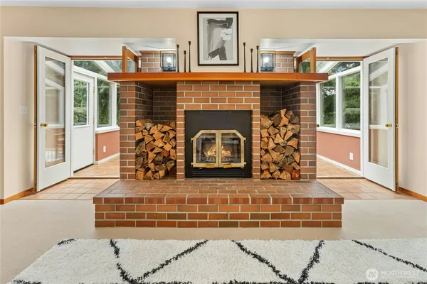a living room with fireplace furniture and a window