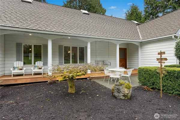 a view of a house with backyard sitting area and garden