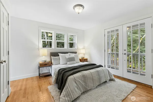 a bedroom with a bed and a large window