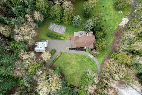 an aerial view of a house with a yard