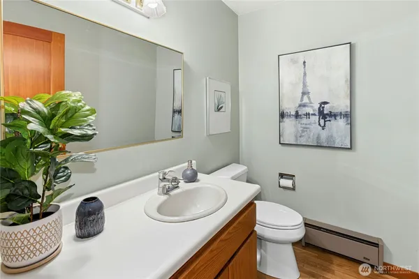 a bathroom with a toilet sink and mirror