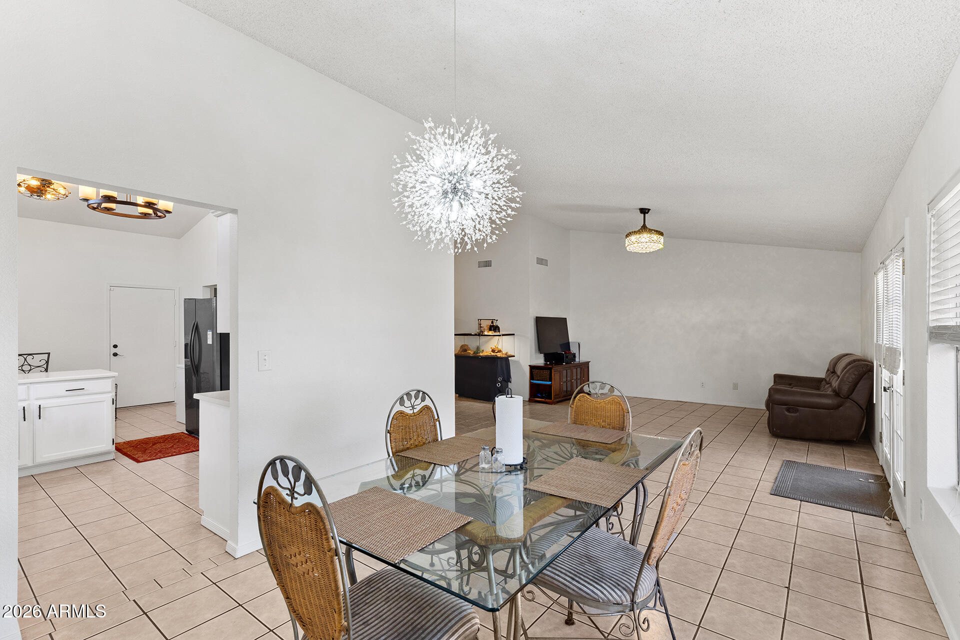 9002 West Coronado Road Phoenix, AZ 85037 - Photo 27 of 54 a view of a dining room with furniture and chandelier