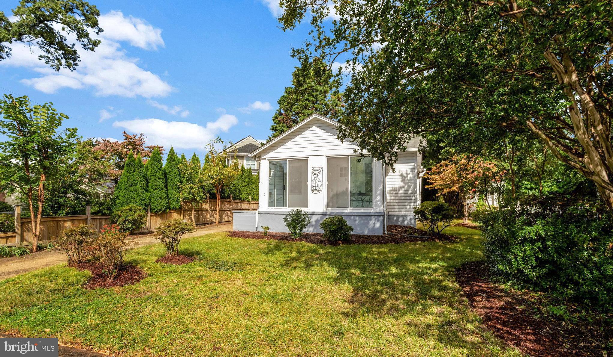 a view of a house with a yard and sitting area
