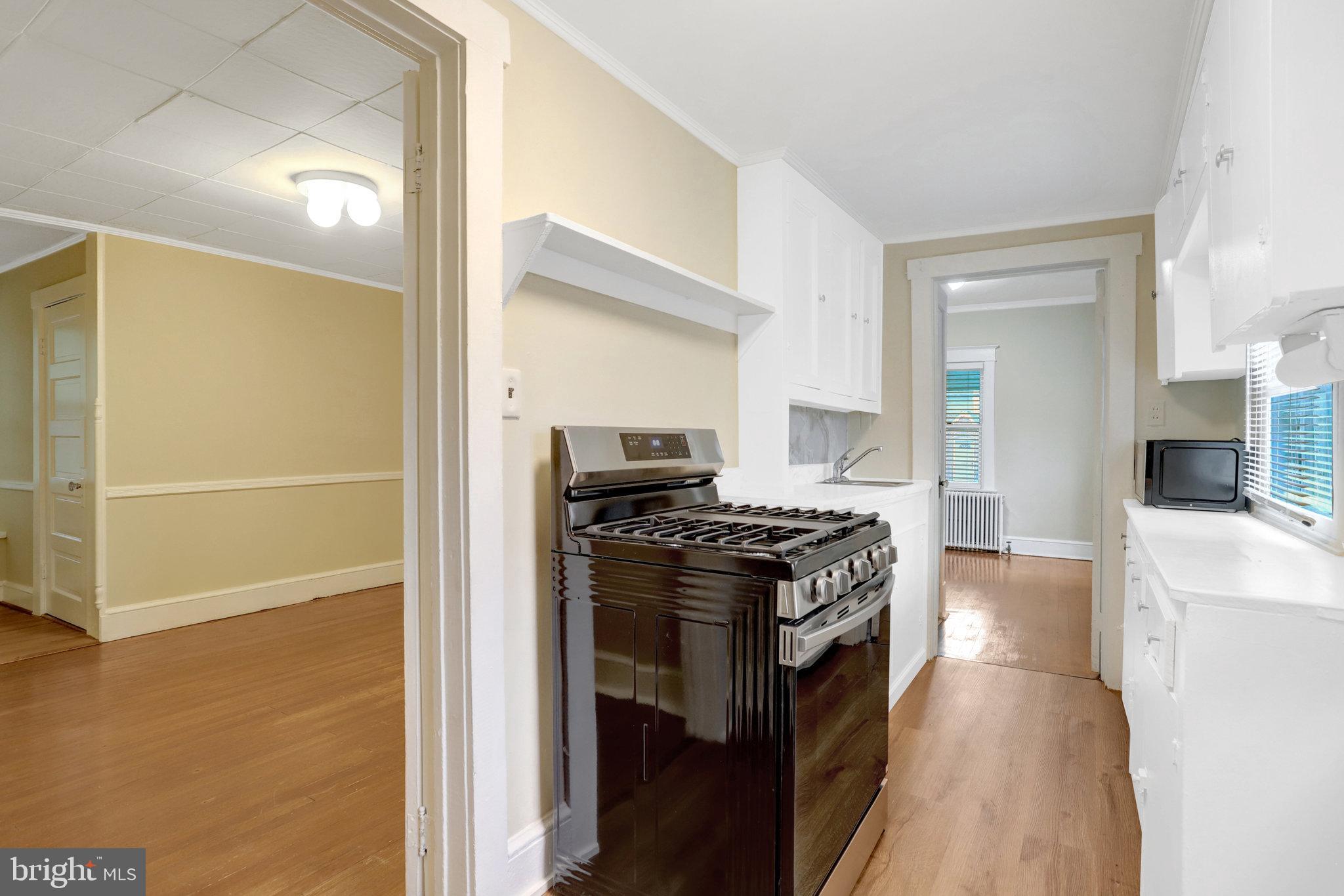 2621 2nd Road North Arlington, VA 22201 - Photo 11 of 44 a kitchen with granite countertop a stove and a refrigerator