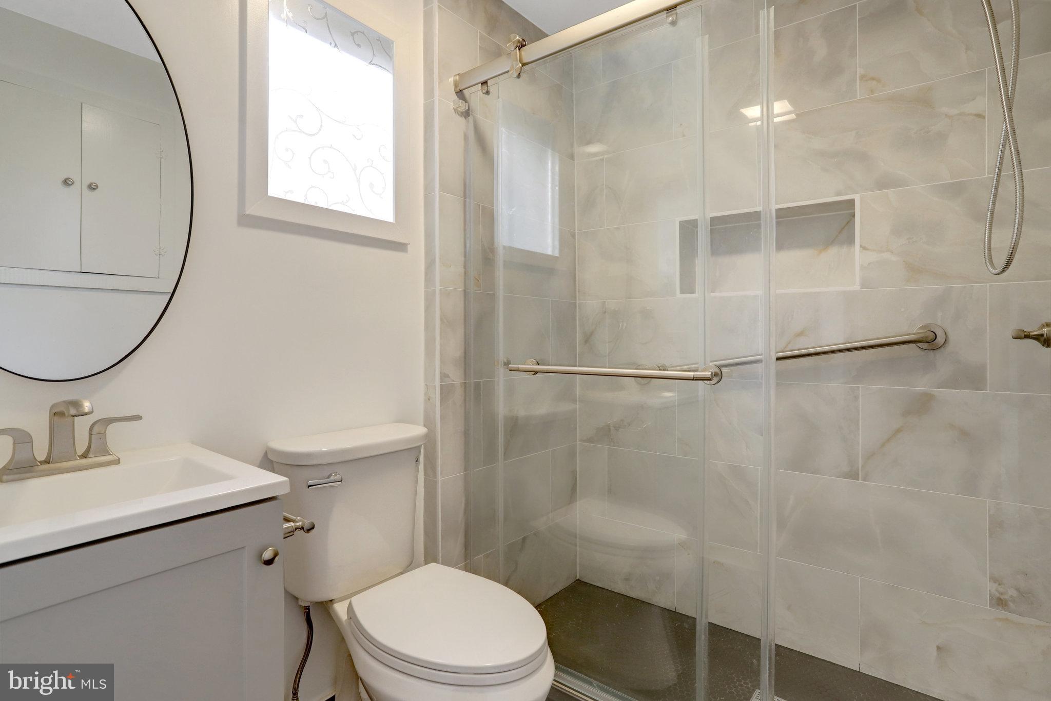 2621 2nd Road North Arlington, VA 22201 - Photo 19 of 44 a bathroom with a sink a toilet and shower