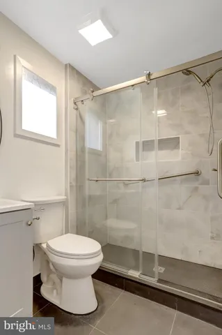 a bathroom with a toilet and a shower