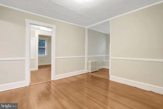 an empty room with wooden floor & closet