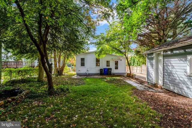 a view of a house with backyard and a tree